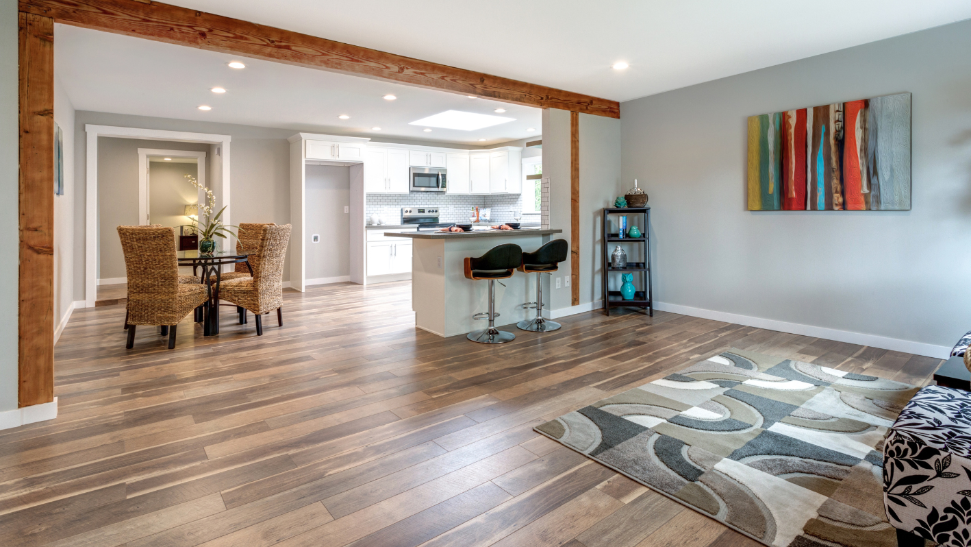 A living room filled with furniture and a kitchen