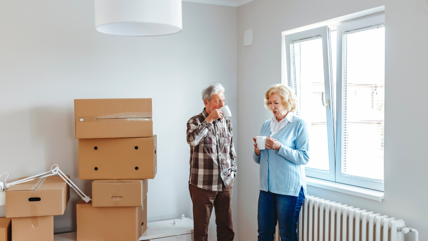 A man and a woman standing in a room with boxes