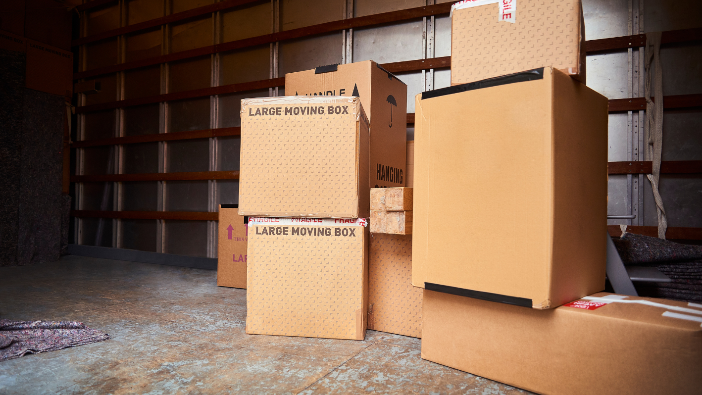 Three boxes stacked on top of each other in a warehouse